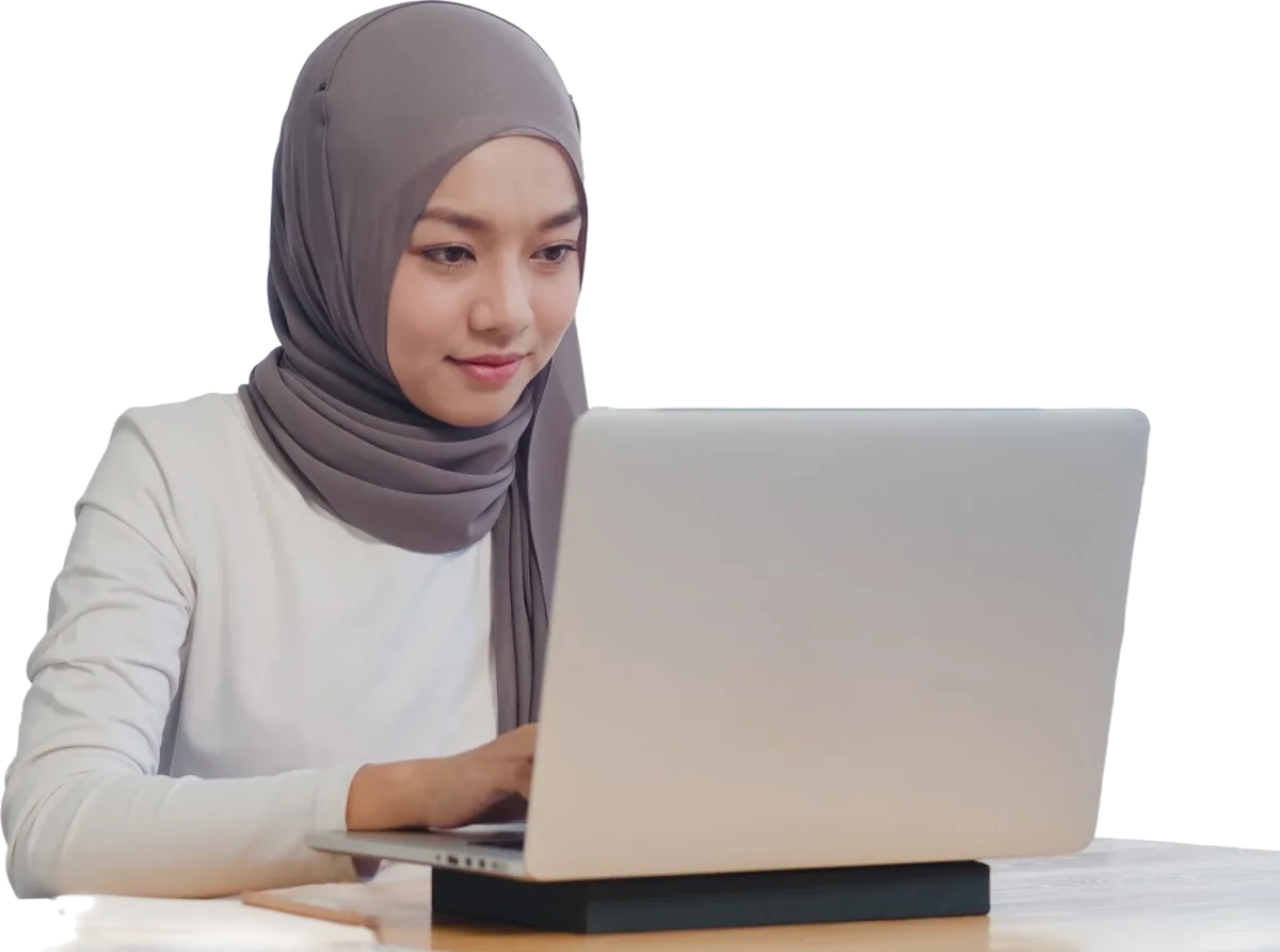 A smiling consultant in a hijab working on a laptop